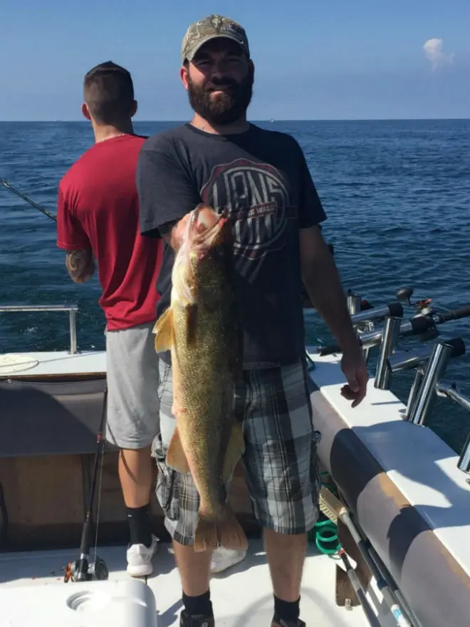 A man holding a fish by its gills